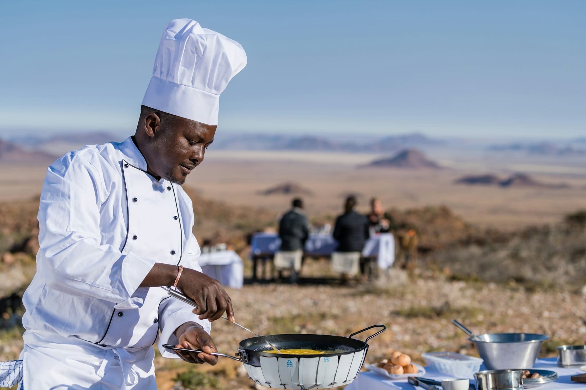 Chef grilling over an open flame at a Dubai desert camp on a Dubai desert safari