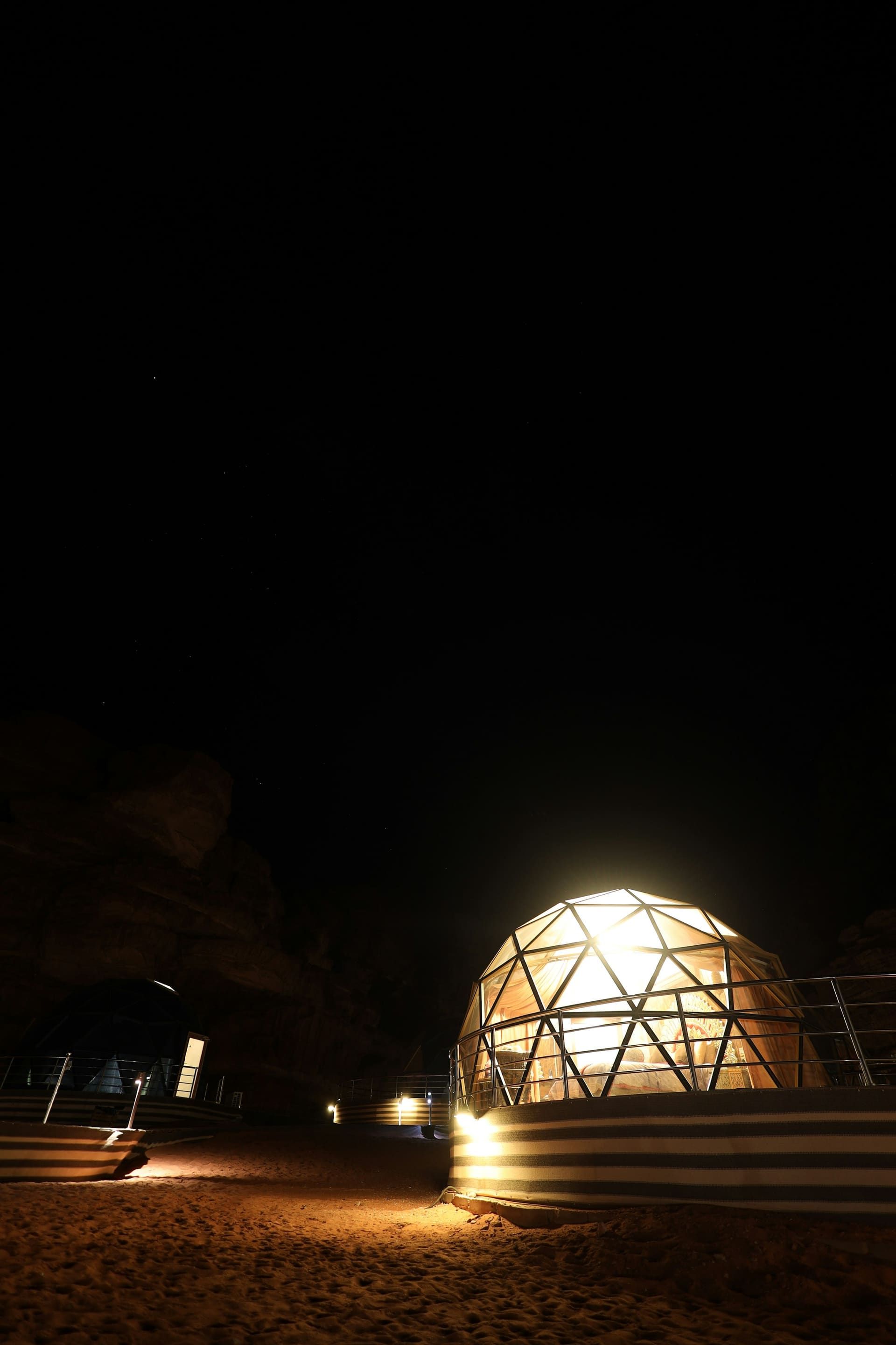 An elegant private majlis dining setup at a desert camp on a VIP desert safari outside Dubai at dusk