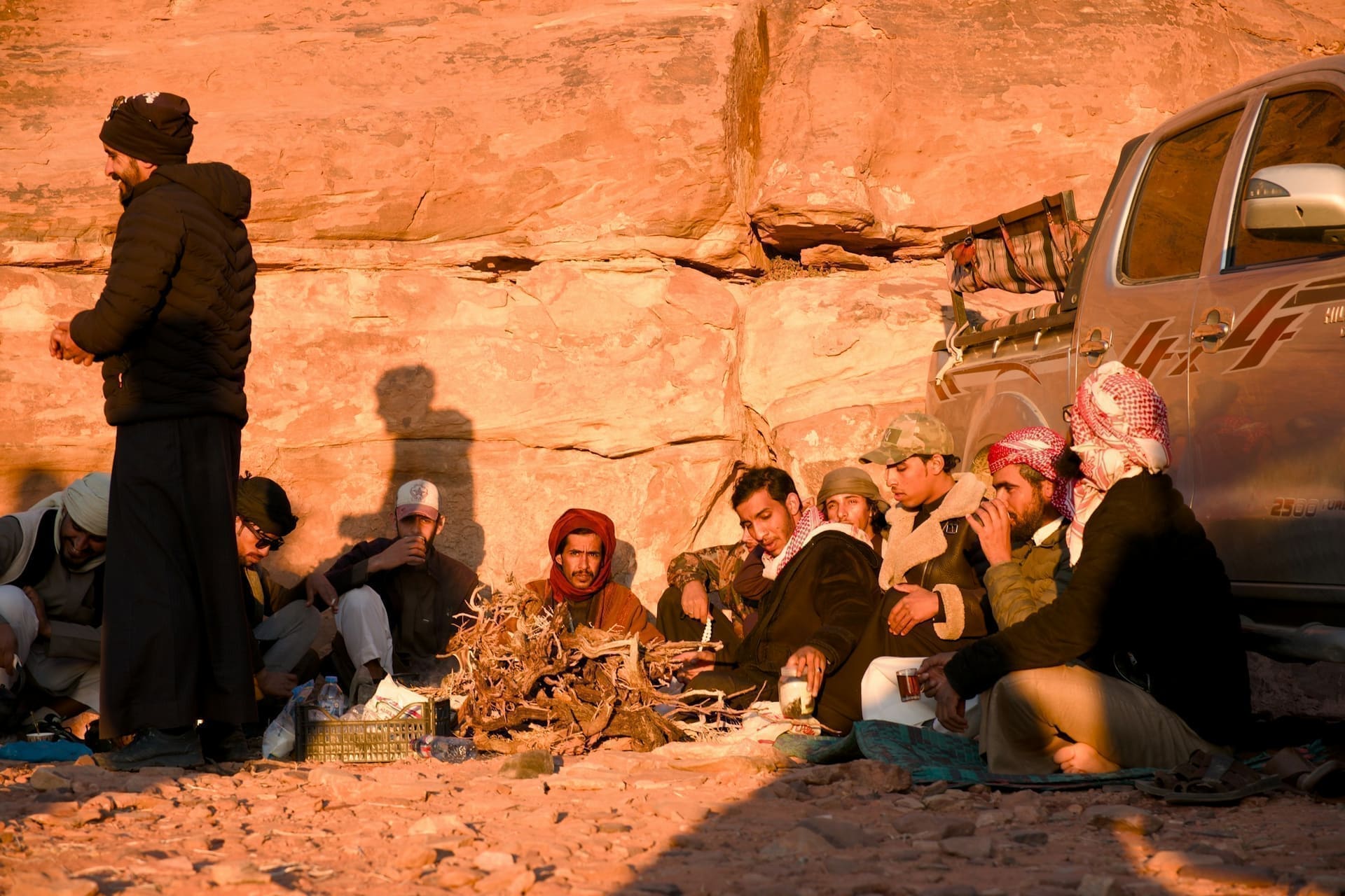 Guests gathered around the desert camp campfire after the BBQ dinner