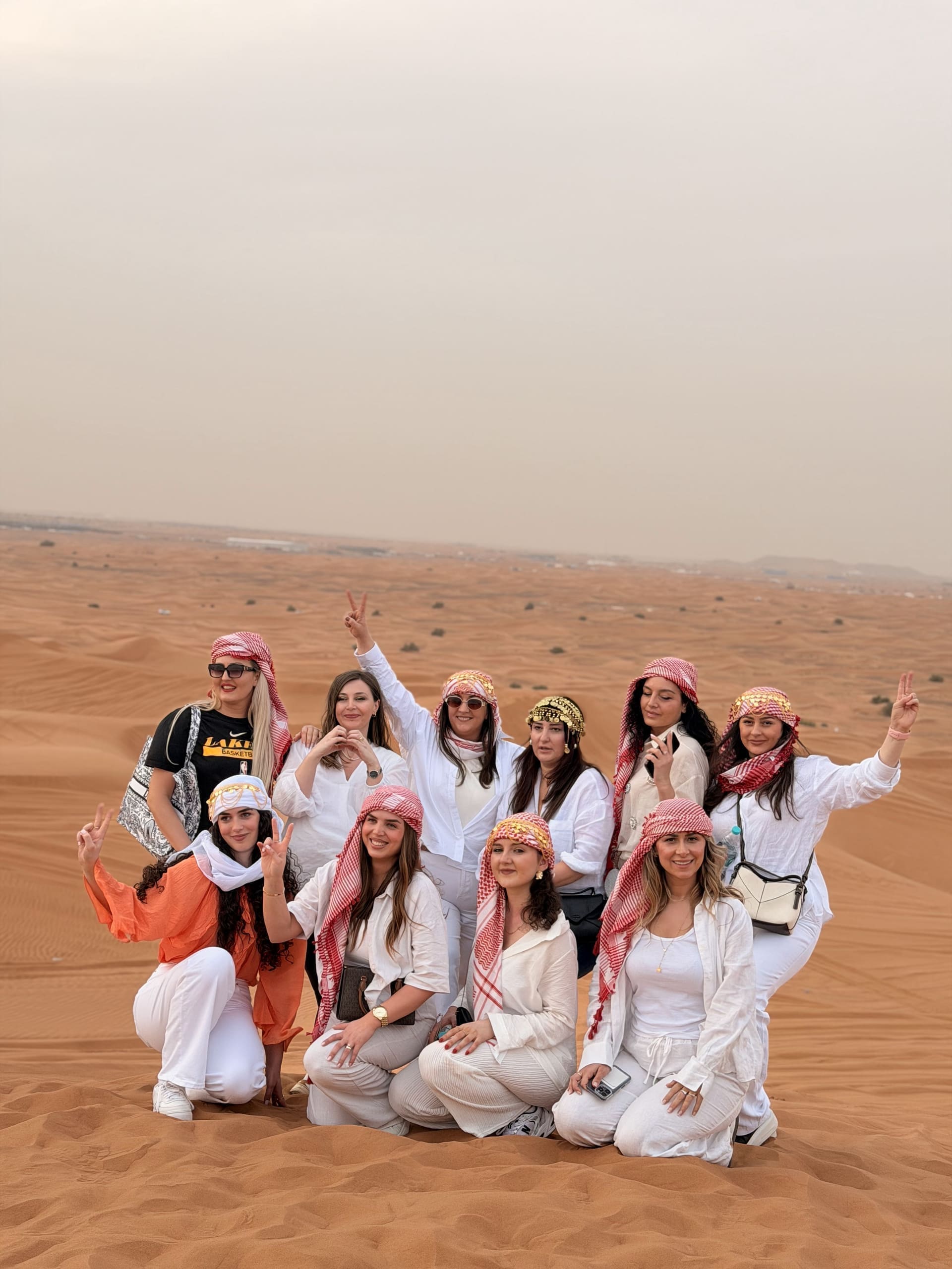 Guests gathered on a red sand dune