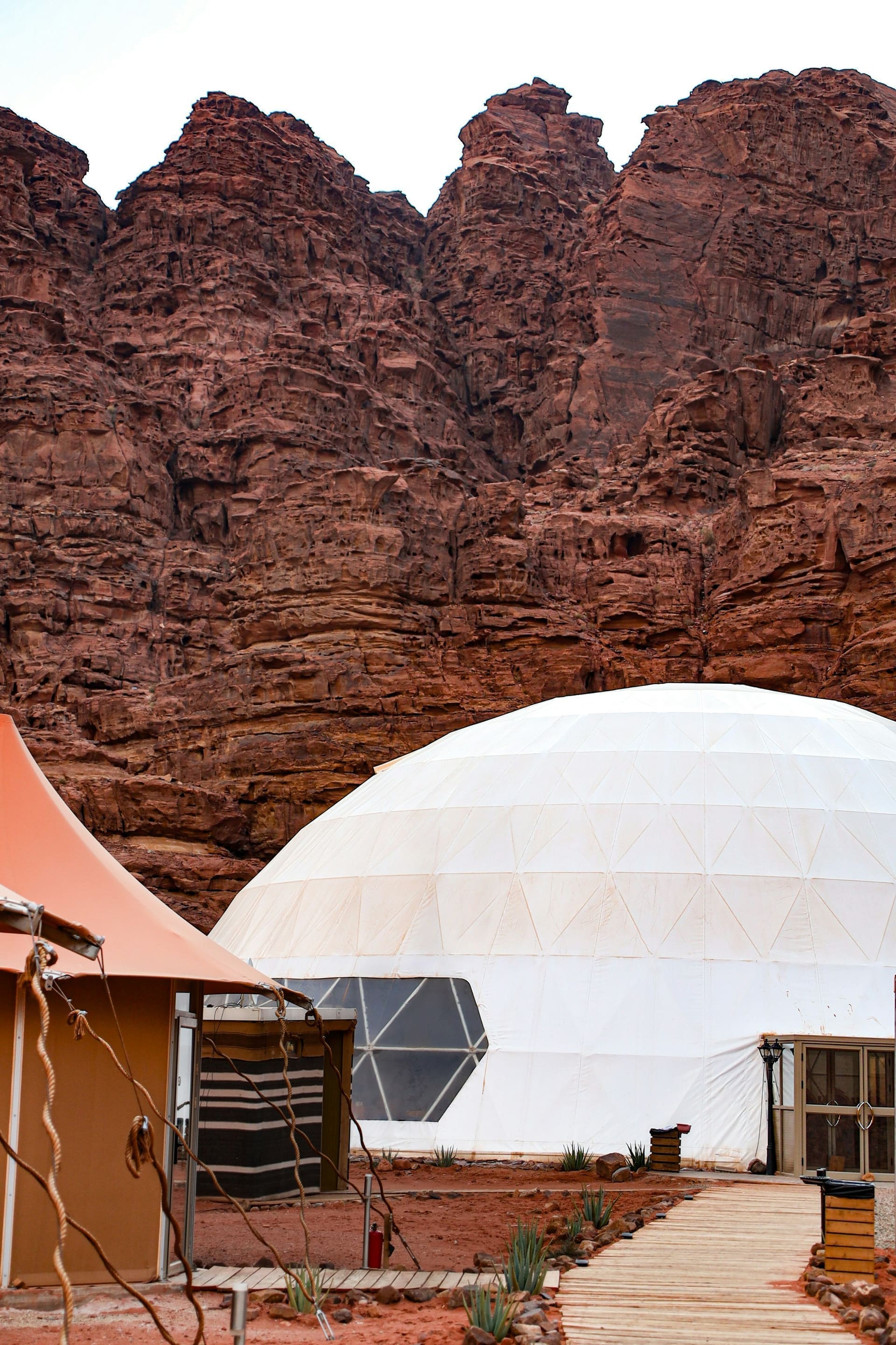 A gold-rim Bedouin sukkat tent at a luxury Dubai desert camp at dusk