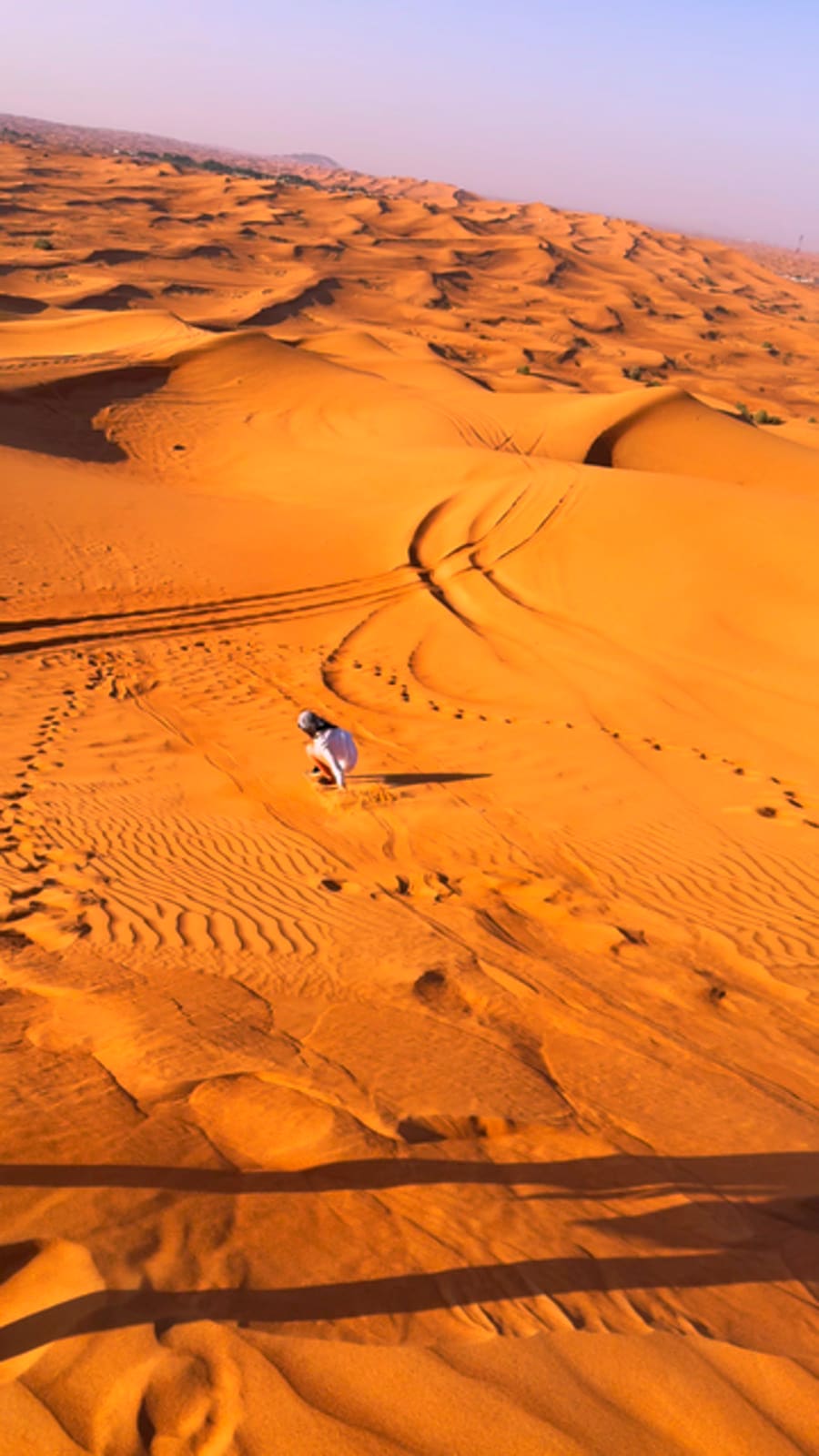 Aerial view over the red Dubai desert dunes